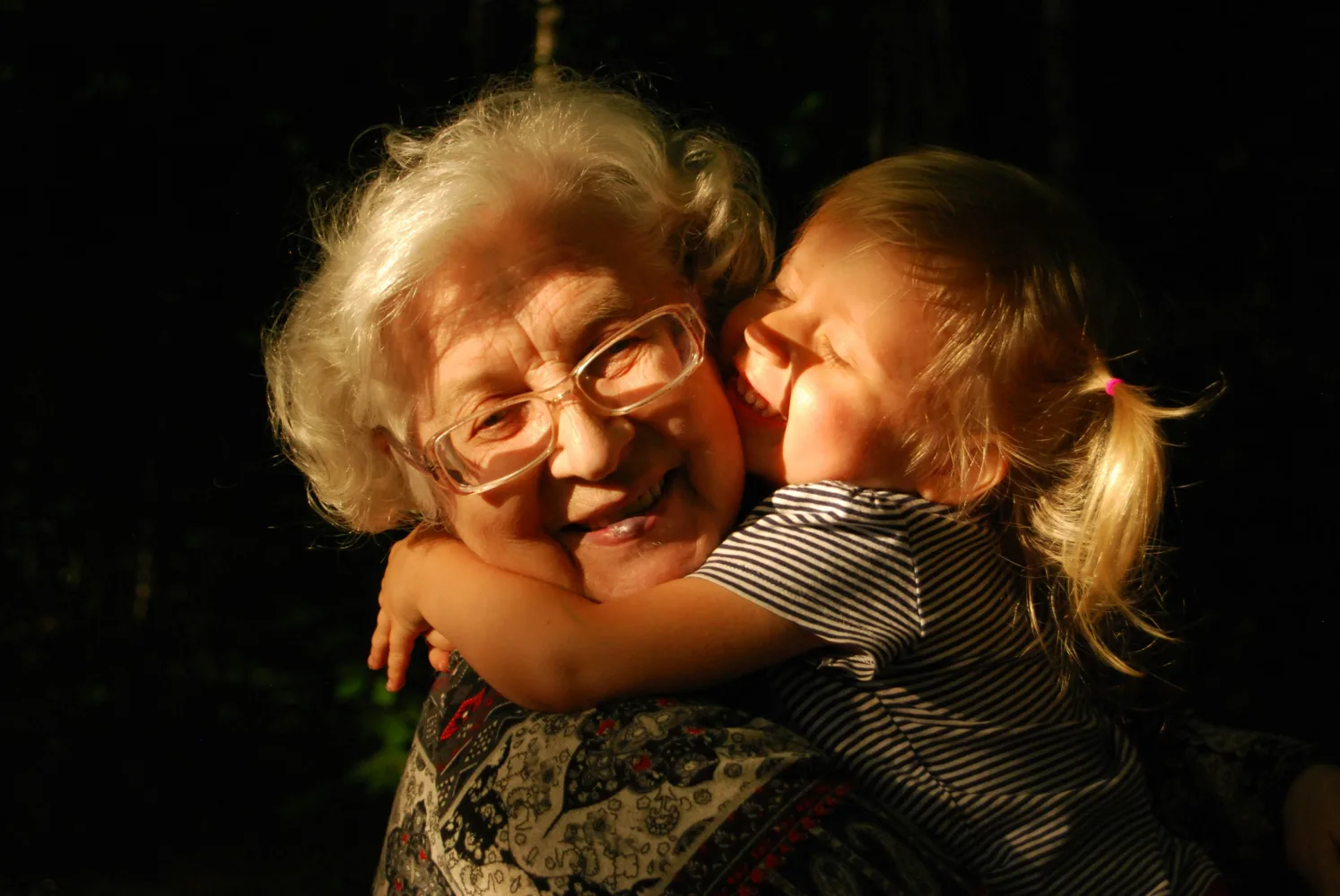 Grandmother embracing her granddaughter, representing grandparents seeking emergency custody orders in Texas