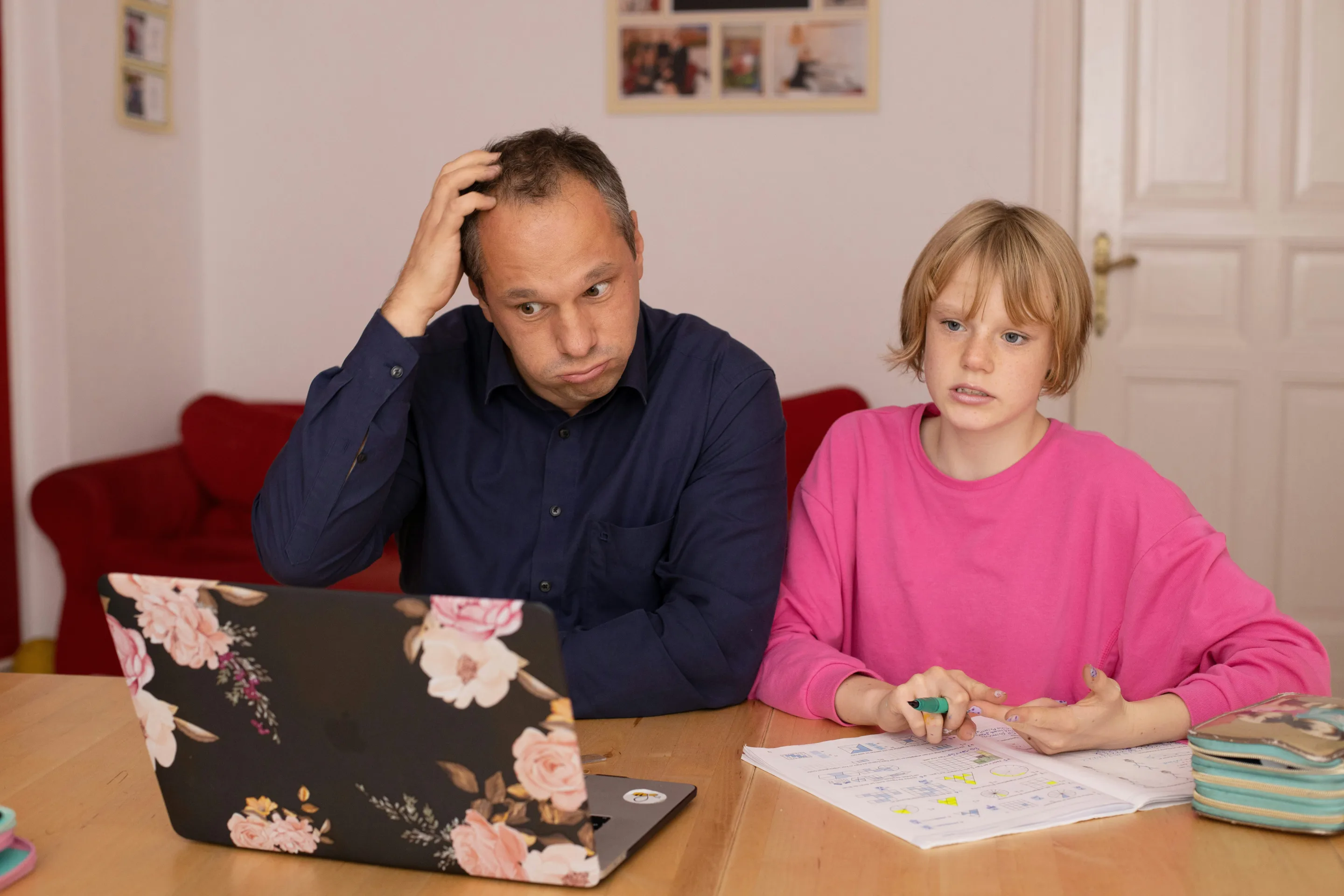 Father and daughter at a kitchen table reviewing paperwork for a custody modification in Texas